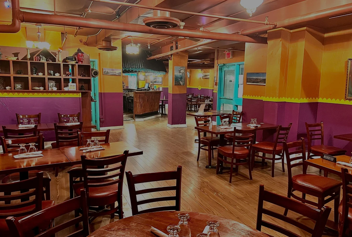Indian restaurant dining room with tables set for guests awaiting takeout pickup in Hamilton